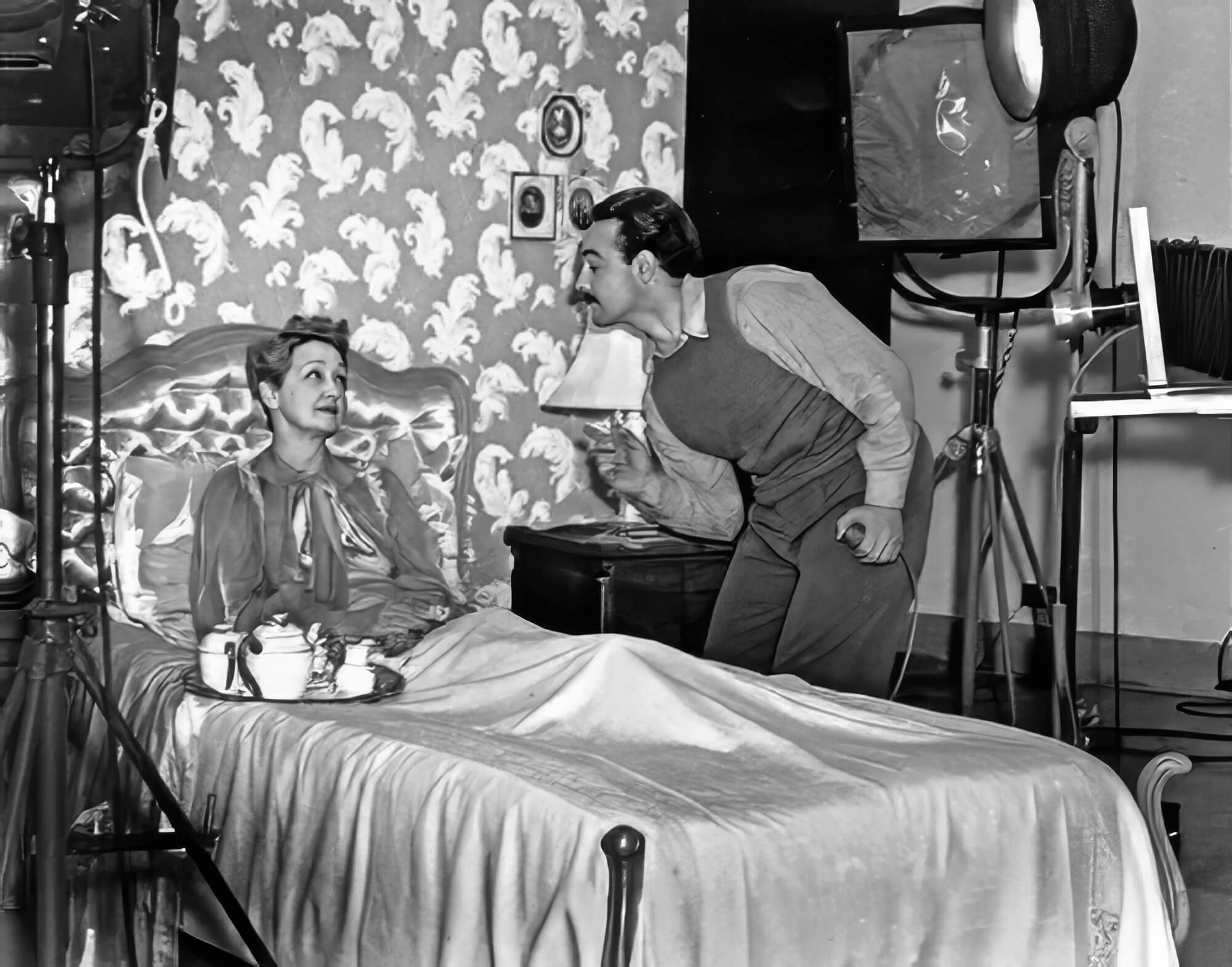 Hollywood columnist Hedda Hopper shares a candid exchange with Tom Kelley while preparing for a portrait session. Hollywood columnist Hedda Hopper shares a candid exchange with Tom Kelley while preparing for a portrait session.