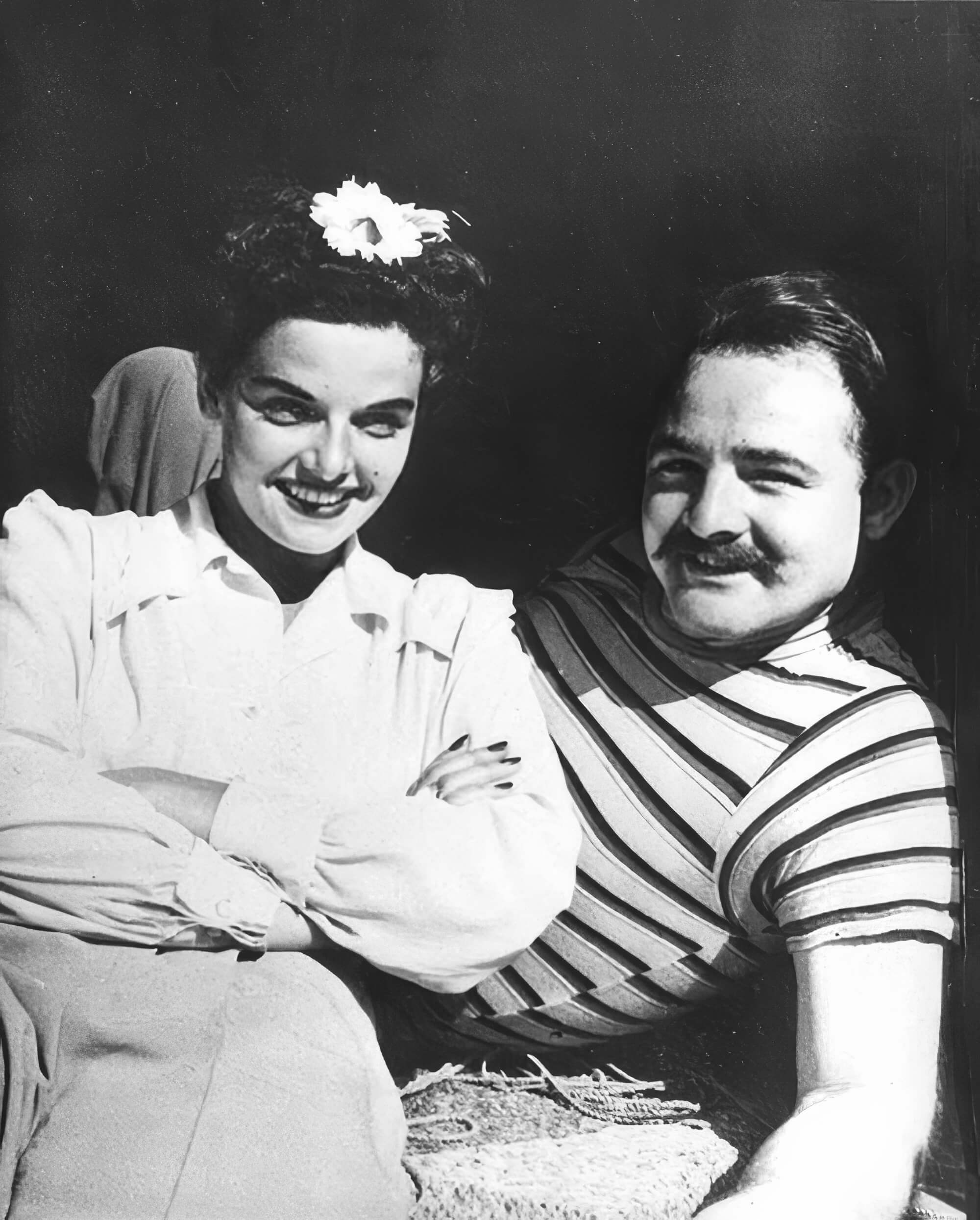 Relaxing between shots, Tom Kelley and actress Jane Russell share a moment of camaraderie during a studio session. Relaxing between shots, Tom Kelley and actress Jane Russell share a moment of camaraderie during a studio session.