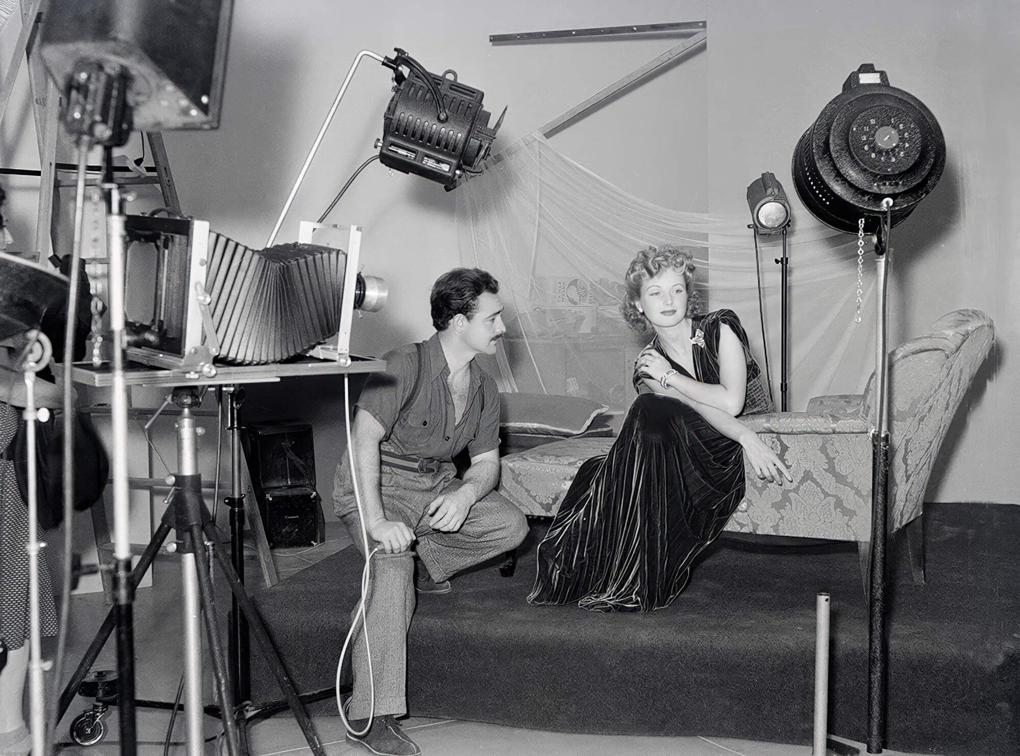 On set with actress Lana Turner, Tom Kelley captures a glamorous pose during a Hollywood photo session. On set with actress Lana Turner, Tom Kelley captures a glamorous pose during a Hollywood photo session.